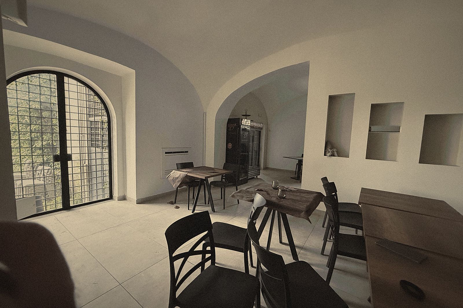 La sala con l'arco e le volte antiche, apparecchiata prima di sera